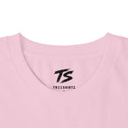 Close-up of a light pink crewneck t-shirt with a black 'TS' logo and 'TREESHIRTZ' printed inside the collar, on a white background.