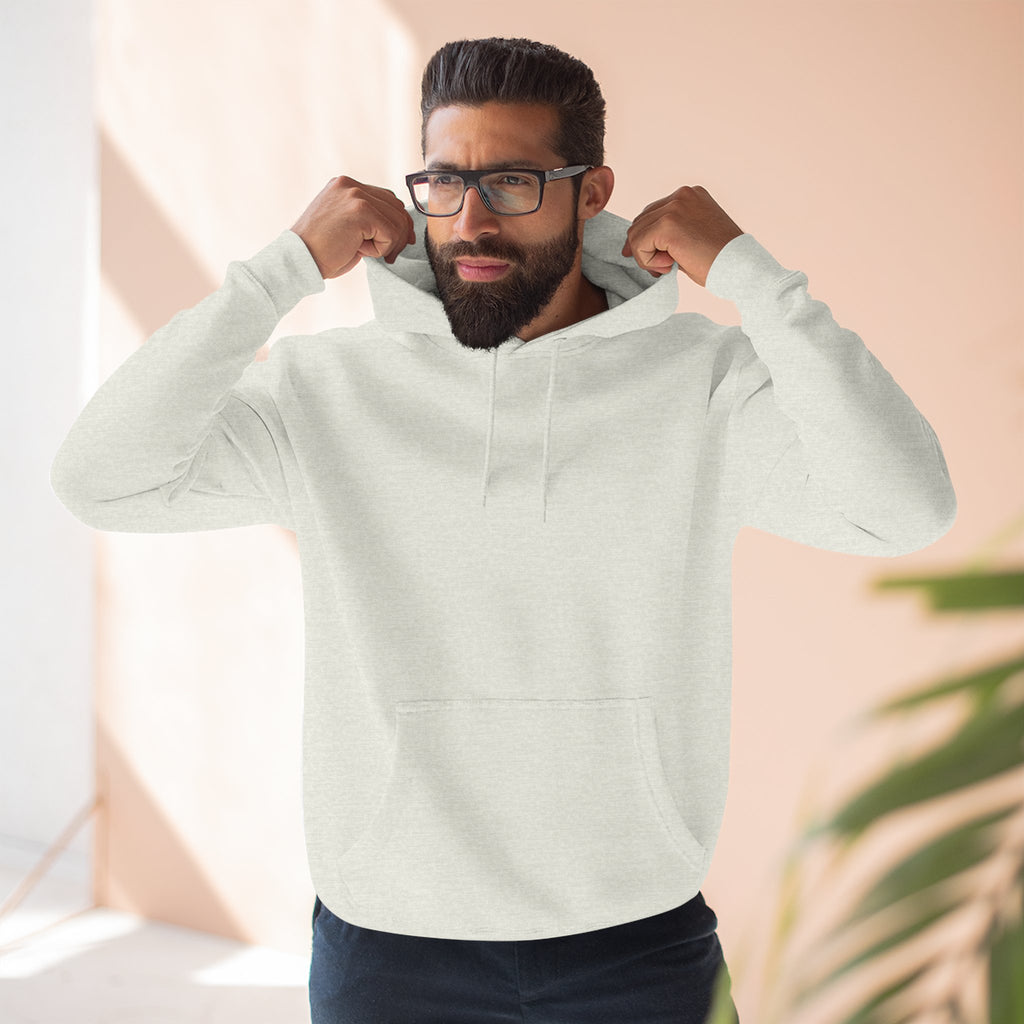 Man wearing a light grey hoodie in a neutral background