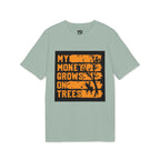 A sage green short-sleeve t-shirt with a graphic print on the front. The graphic features a black rectangular background with distressed orange text reading 'MY MONEY GROWS ON TREES' and a black tree silhouette.