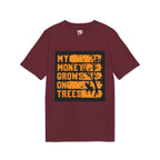 A maroon short-sleeve crewneck t-shirt with a graphic print on the front. The graphic features a black background with distressed orange text reading 'MY MONEY GROWS ON TREES' and a black tree silhouette.